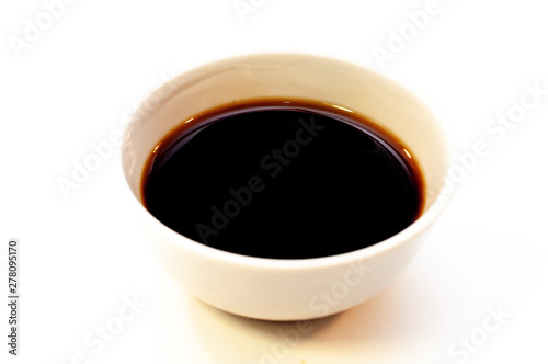 Sauce boat with soy sauce on white background