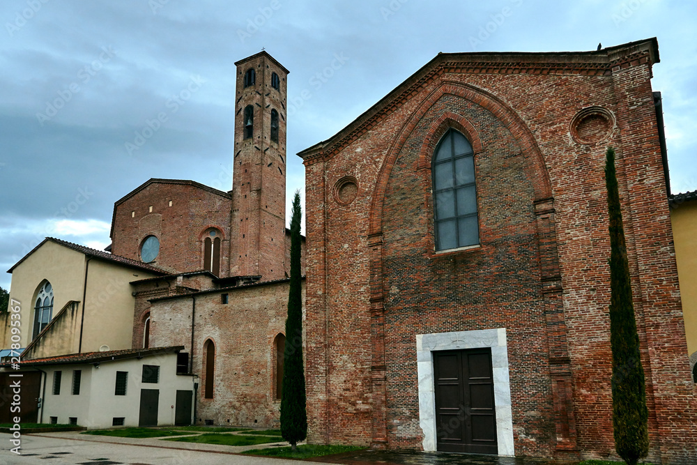 Stone, medieval church with a bell tower in the city of Lukka in Toscana, Italy.