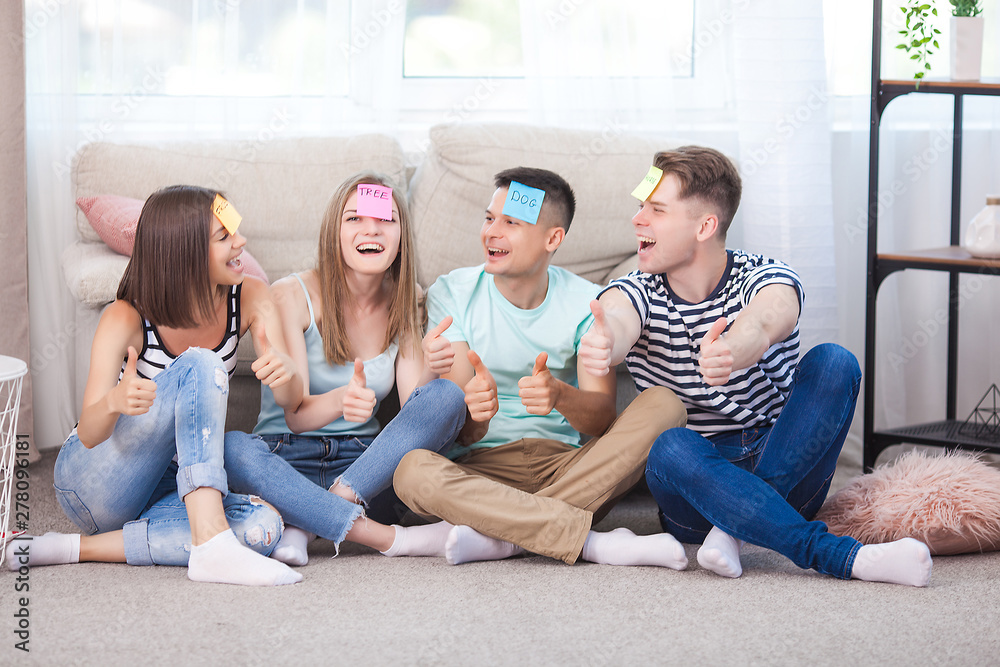Group of young people playing games indoors. Active youth. Happy smiling people having fun. Students at the holidays. Group of young people playing games indoors. Active youth. Happy smiling people having fun. Students at the holidays.