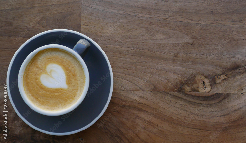 Macro photo cup of coffe cappucino in a yellow cup. Painted heart on skin coffe Macro photo cup of coffe cappucino in a yellow cup. Painted heart on skin coffe