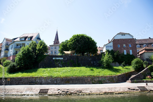 blick auf die kirchturmspitze umgeben von gebäuden in der Nähe von Heidelberg Deutschland fotografiert während einer Schiffsrundfahrt auf dem Neckar bei Sonnenschein