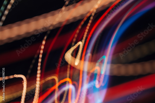 Colorful pattern of orange, red and blue dynamic lines of light. Modern blurred background. Art concept of lighting effects.