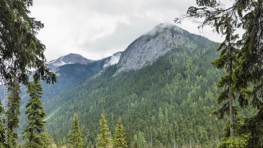 Mountain landscape with moving clouds in summer. Glacier National Park, BC, Canada - Timelapse Mountain landscape with moving clouds in summer. Glacier National Park, BC, Canada - Timelapse