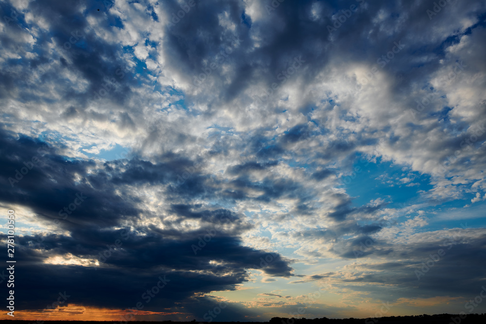 Beautiful sunset - dark sky with clouds and sunlight