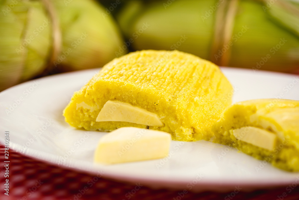 pamonha, Brazilian sweet made from homemade cheese with corn. Open pissing ready for consumption. Concept of traditional Brazilian sweet, typical food of the months of June and July. pamonha, Brazilian sweet made from homemade cheese with corn. Open pissing ready for consumption. Concept of traditional Brazilian sweet, typical food of the months of June and July.