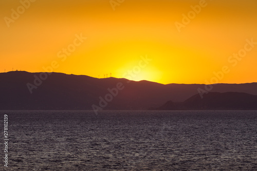 Sunset on the Saronic Gulf islands dotted with wind turbines