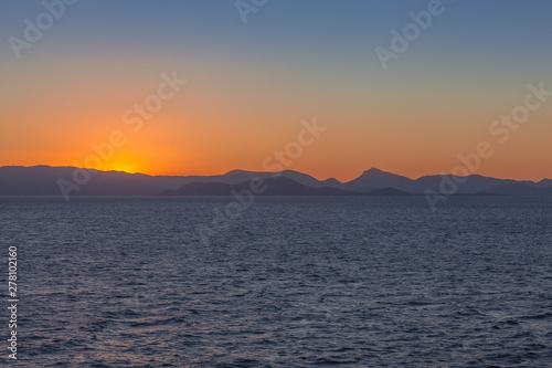 Sun setting behind the profile of Saronic Gulf islands