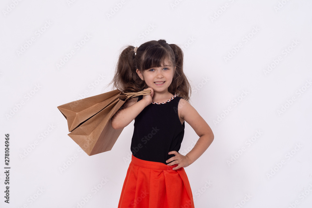 Cute little girl on shopping. Kid with shopping bags. Child in dress goes  to shop to buy. foto de Stock | Adobe Stock