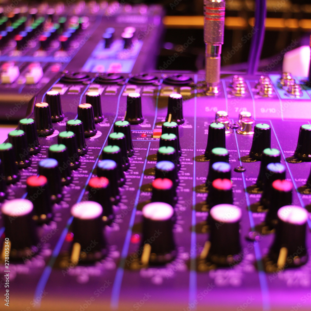 Fototapeta premium recording studio professional audio mixer close-up, blurred in purple color