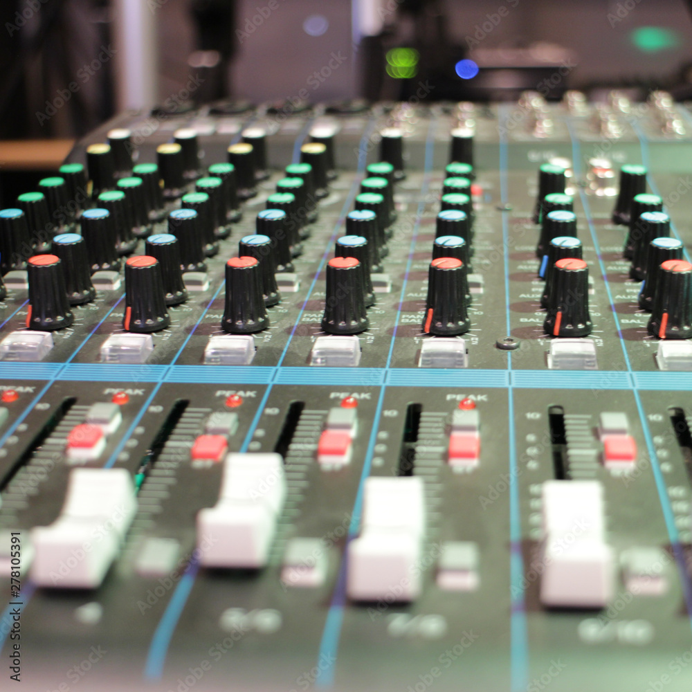 recording studio professional audio mixer close-up, blurred