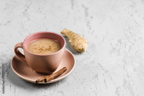 Tea masala in a Cup on the plate with the winter spices of cinnamon and ginger