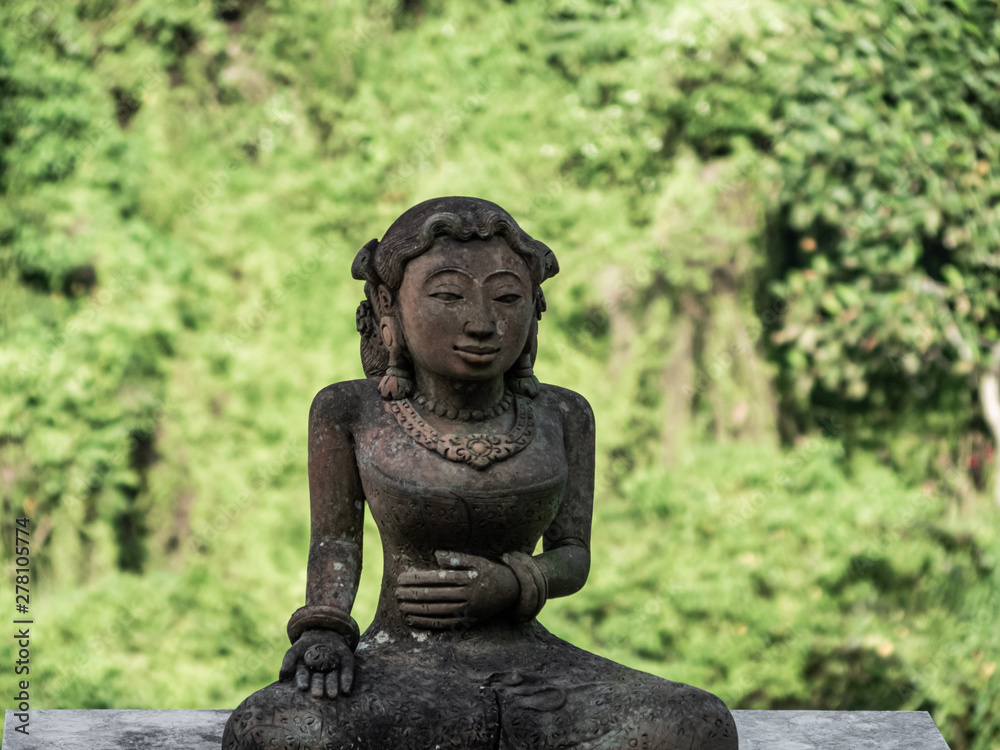 Obraz premium traditional statue head of a women made of stone in Bali, Indonesia