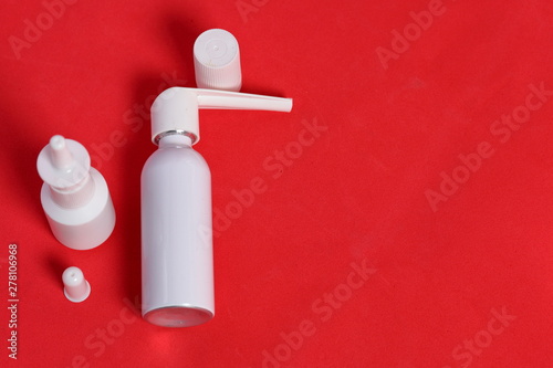 White spray nasal and oral spray. Against the background of coral color. View from above.