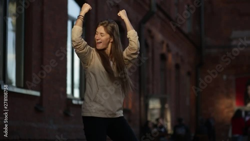 A girl with long hair dances and rejoices