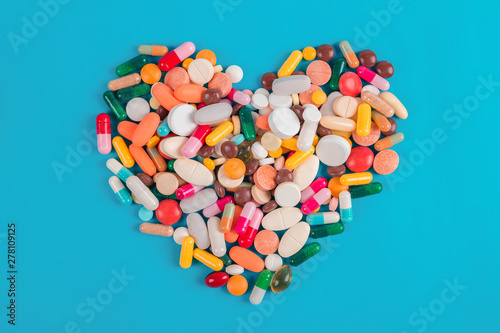 Heart made of colorful pills on blue background, Heart disease medications, Drugs for Heart Disease
