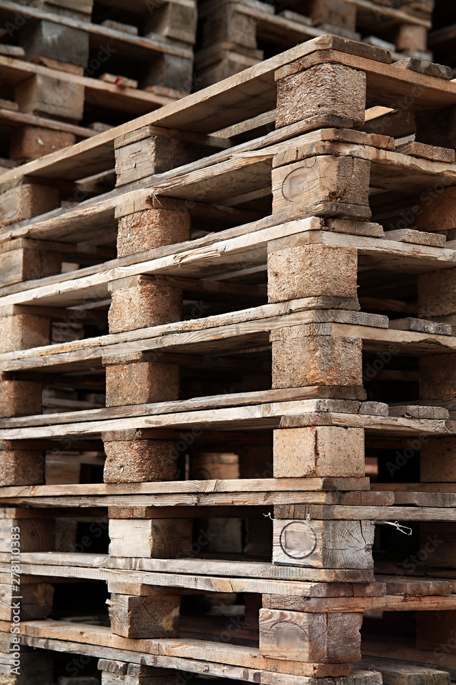 wooden pallets stacked high on top of each other in a companys factory yard in london no people stock photo wooden pallets stacked high on top of each other in a companys factory yard in london no people stock photo