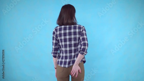 woman's hand holding her bottom because is pain caused by hemorrhoid on blue background