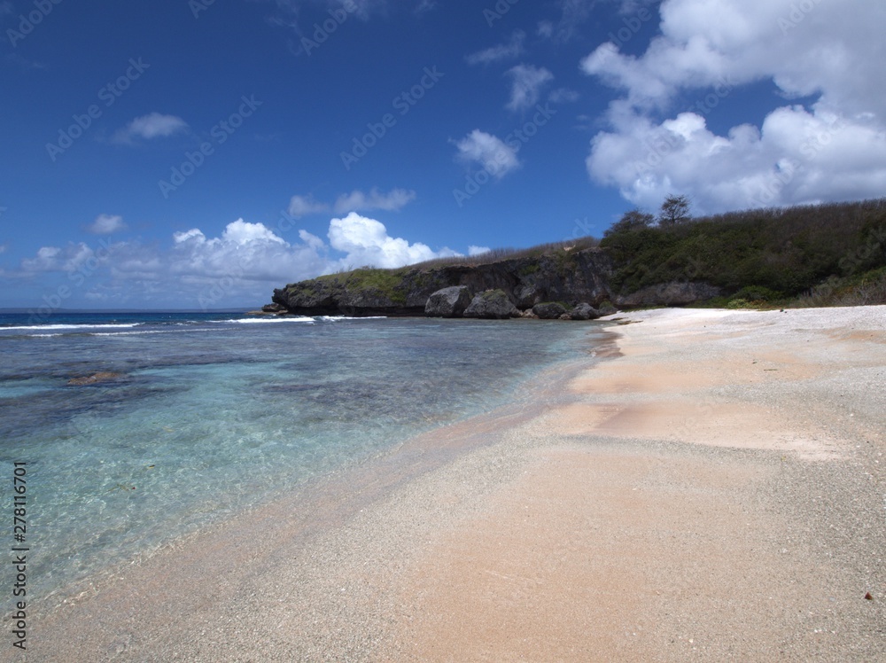 Scenic stretch of white sand and crystal-clear waters at Ladder Beach, Saipan