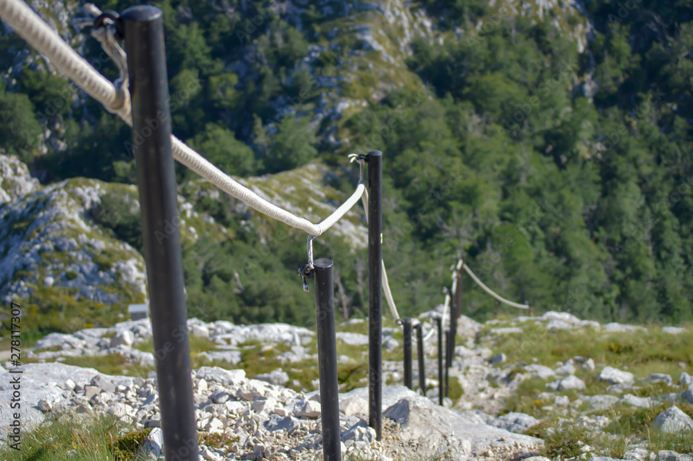 Stony road with rope fence on the peak Sv. Jure in Biokovo national park, Croatia Stony road with rope fence on the peak Sv. Jure in Biokovo national park, Croatia