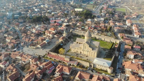 4k aerial view of Svetitskhoveli Orthodox Cathedral, and touristic town Mtskheta, Georgia in a sunrise photo