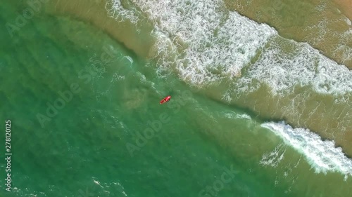 Beautiful view of the sea from above whirls above the surfers