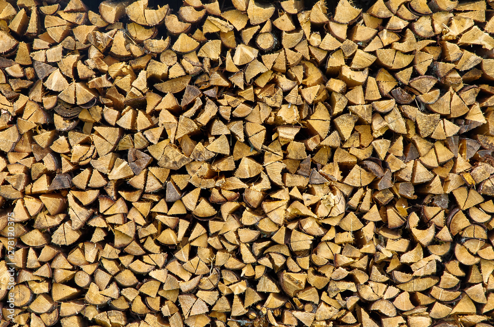 stacked firewood, logs harvested for the winter, background image