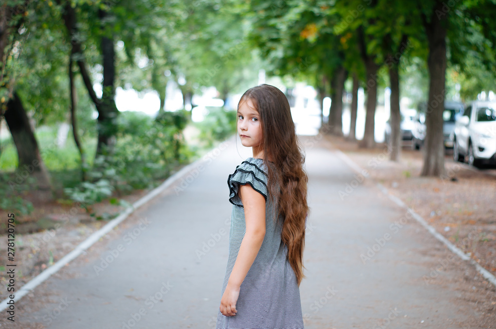 Little cute girl street city lifestyle shooting, summer, smiling at camera Little cute girl street city lifestyle shooting, summer, smiling at camera