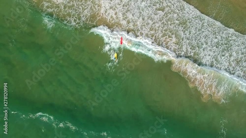 Circling over the sea and surfers on the waves