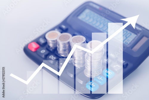 Double exposure of graph and rows of coins with calculator for finance and business concept