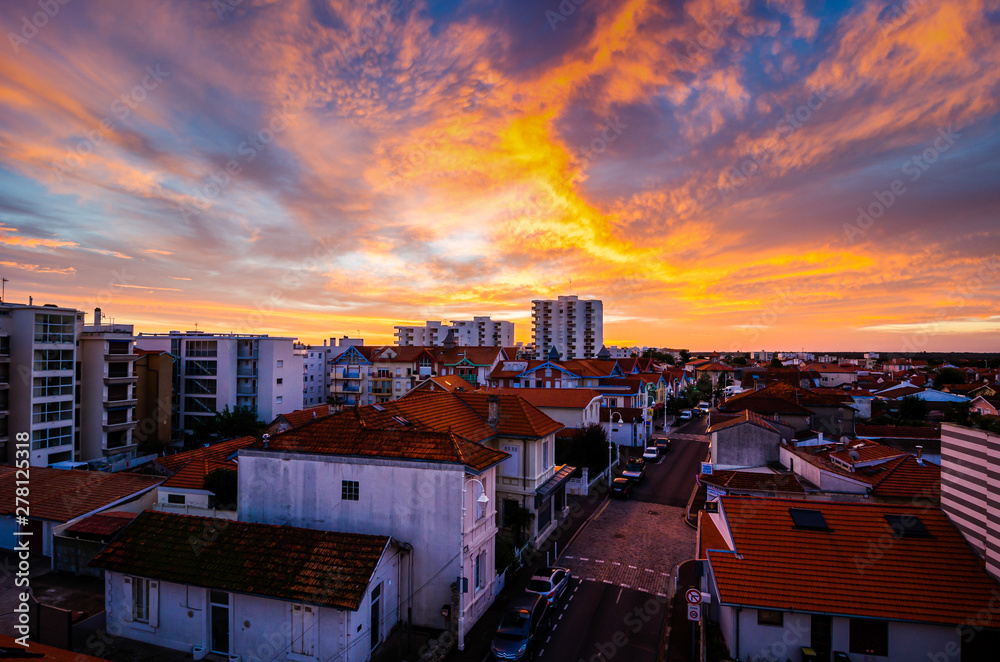 Arcachon, France - October 23, 2013. Fiery sunset with clouds above city