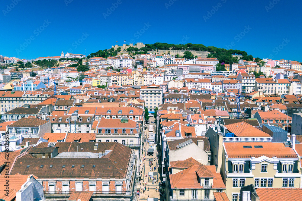 Red tiles and rooftops kissed by the sun above Lisbon.