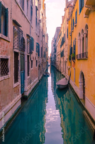 Narrow empty street canal in Venice.