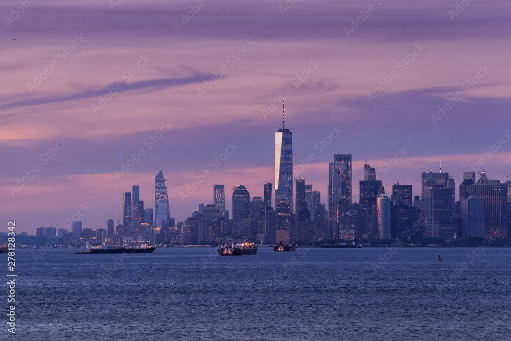 New York City Manhattan skyline at dusk after sunset, view from New York Bay, water view