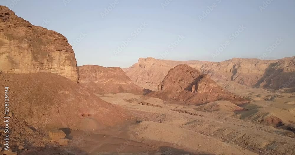 Flying over rocky desert mountains  Aerial view of Rocky Desert Mountains in Sasgon Timna Valley, Negev, Arava, Israel
