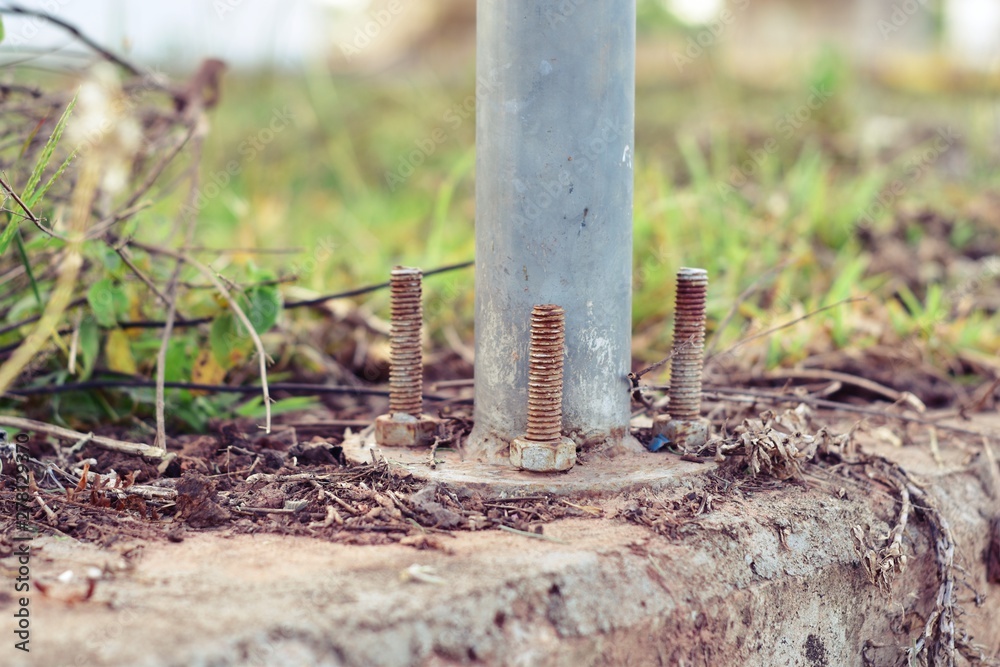 Steel poles attached to the floor with screws Steel poles attached to the floor with screws