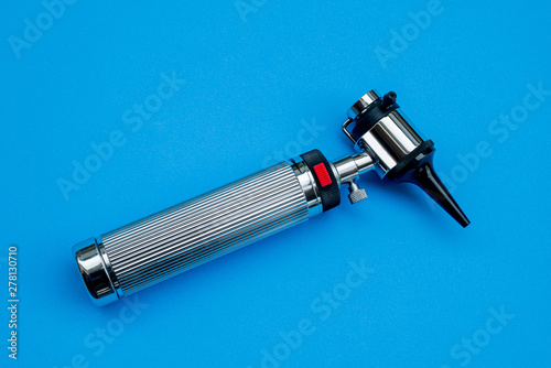Medical Equipment Otoscope on blue background photo