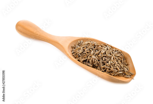 caraway seeds in wood scoop on white background
