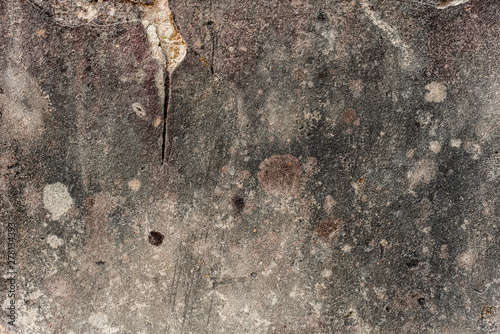 Texture of a concrete wall with cracks and scratches which can be used as a background