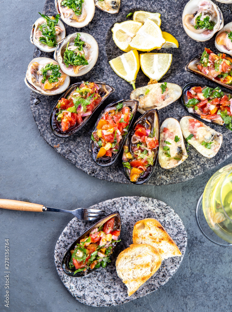 Seafood assorted platter Macha and mussels a la parmesana, mussels a la chalaca, clams with herb sauce Seafood assorted platter Macha and mussels a la parmesana, mussels a la chalaca, clams with herb sauce
