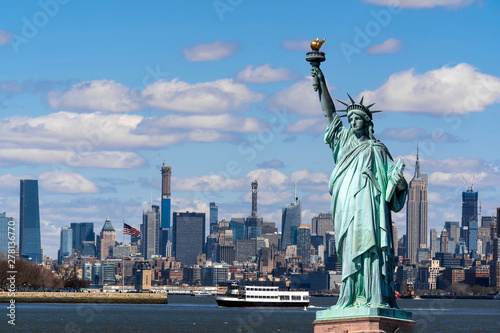 Fototapeta The Statue of Liberty over the Scene of New york cityscape river side which loca