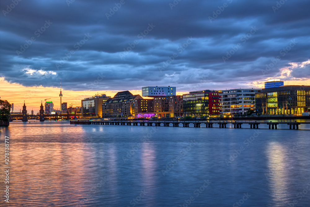 Beautiful sunset at the river Spree in Berlin with the famous Television Tower in the back