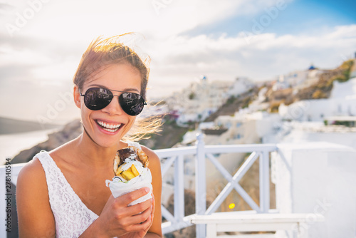 Billede på lærred Greek food gyro pita tourist woman eating local typical sandwich on Greece vacation travel