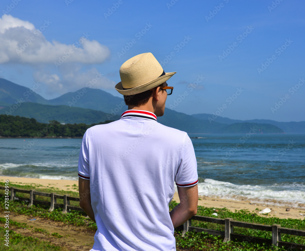 A young man enjoying the blue sea
