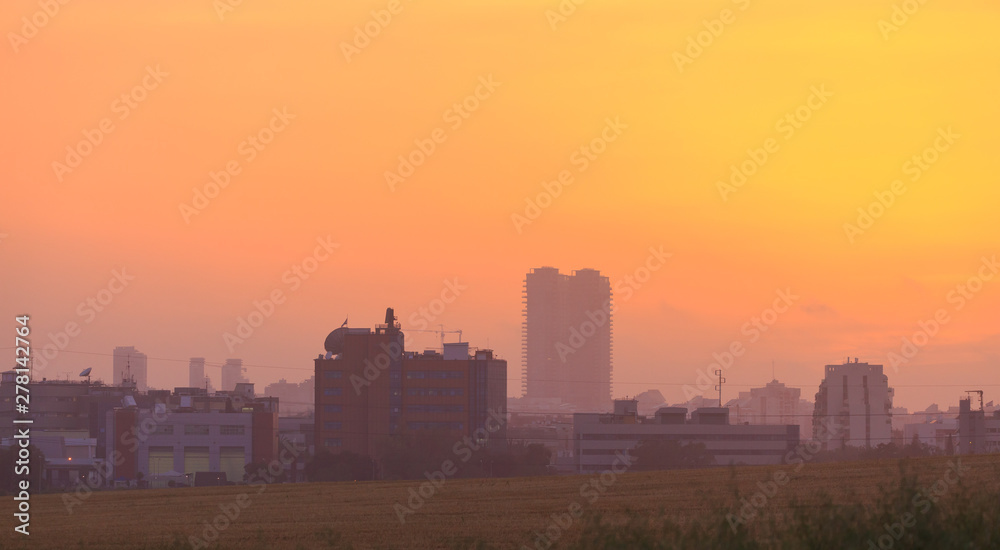 Golden sunset over a tall city buildings