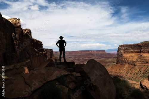 Hiker in cowboy hat at overlook - Silhouette on Shafer Trail - Canyonlands