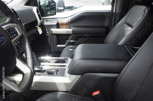 Interior shot of passenger and driver side of a new 2019 Ford F-150 LAriat at a car dealership in Canada © beckisaurus