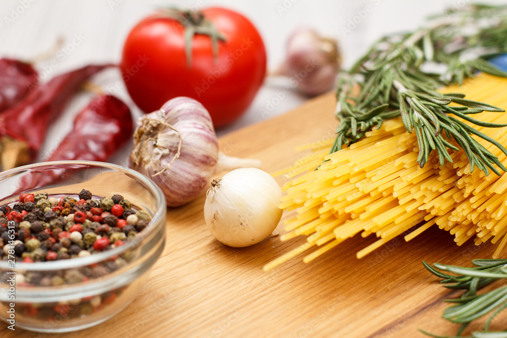 Spaghetti and ingredients for cooking meat or fish on wooden boards. Spaghetti and ingredients for cooking meat or fish on wooden boards.