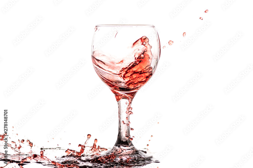 Red wine splash in a round glass on a white background Red wine splash in a round glass on a white background