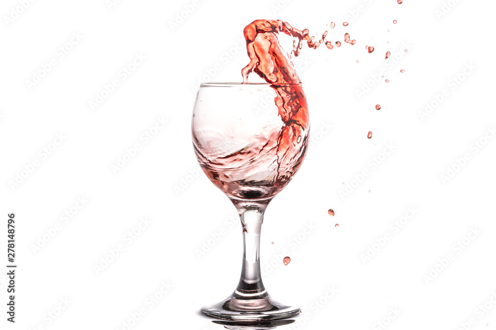 Red wine splash in a round glass on a white background Red wine splash in a round glass on a white background