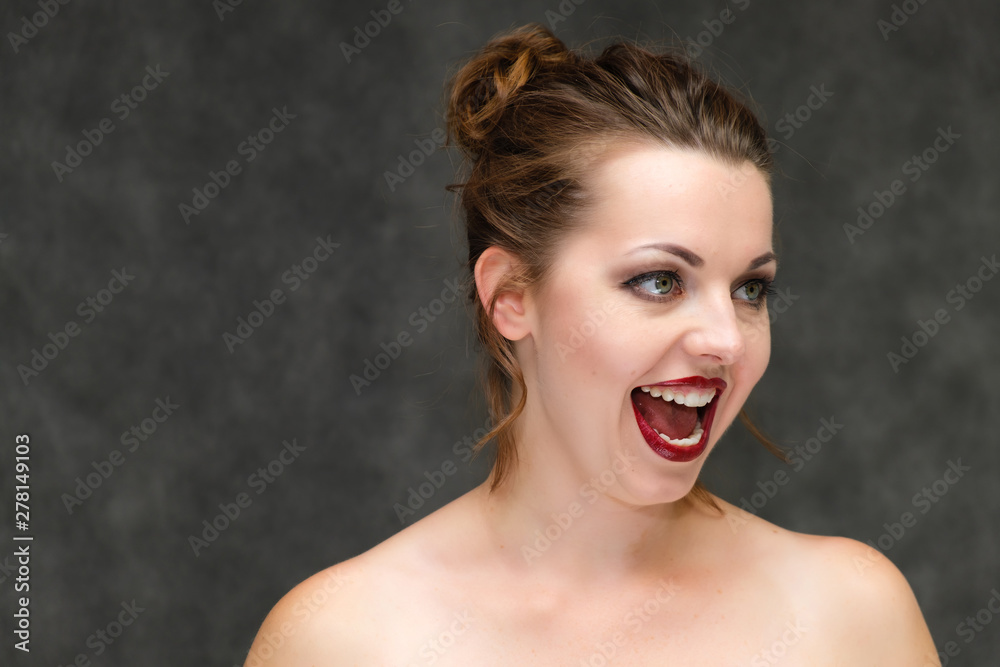 Close-up portrait on a gray background of a pretty young brunette woman with perfect skin of the face. Beauty, great makeup. Talking with emotions. Close-up portrait on a gray background of a pretty young brunette woman with perfect skin of the face. Beauty, great makeup. Talking with emotions.